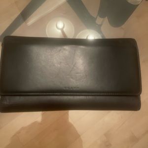 Coach black leather wallet with several large compartments for all your needs.
